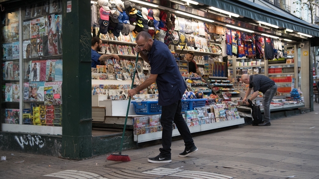 Staff prepare their shop for opening on Las Ramblas following the terror attack