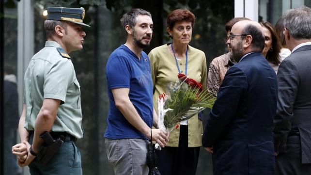 A man brings a bunch of flowers to the Embassy of Spain in Paris