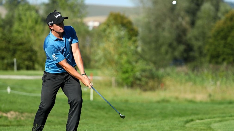 Paul Dunne chips to the 15th green