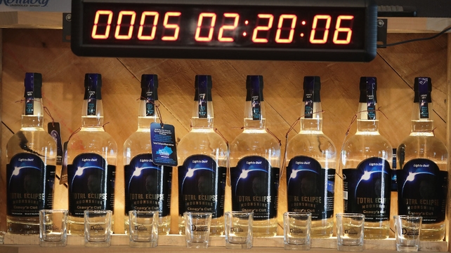 An countdown clock over a display of Total Eclipse Moonshine distilled to commemorate the eclipse, at Casey Jones Distillery in Hopkinsville, Kentucky