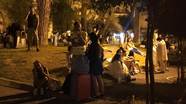 People wait in the streets after the quake hit