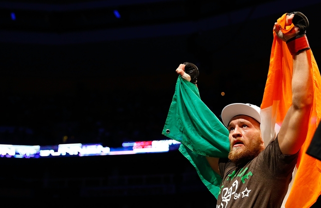 Conor celebrates his win against Max Holloway in their featherweight bout on August 17, 2013