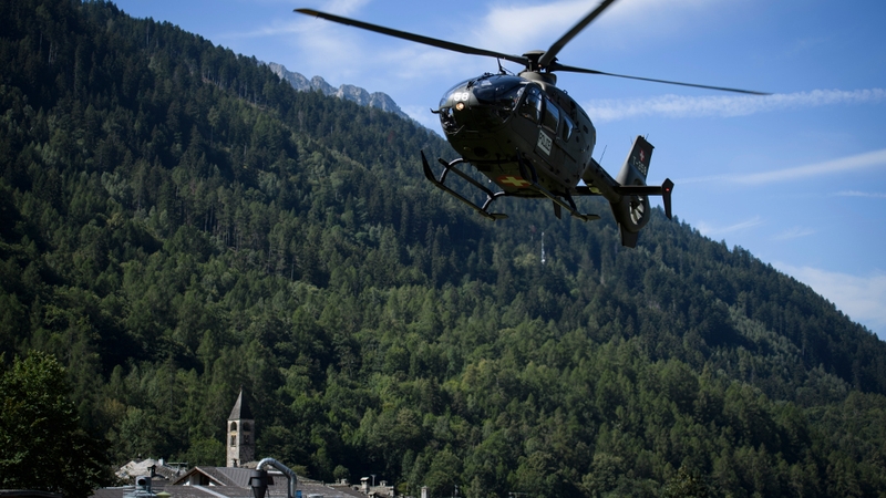 A helicopter is seen over Bondo after the landslide