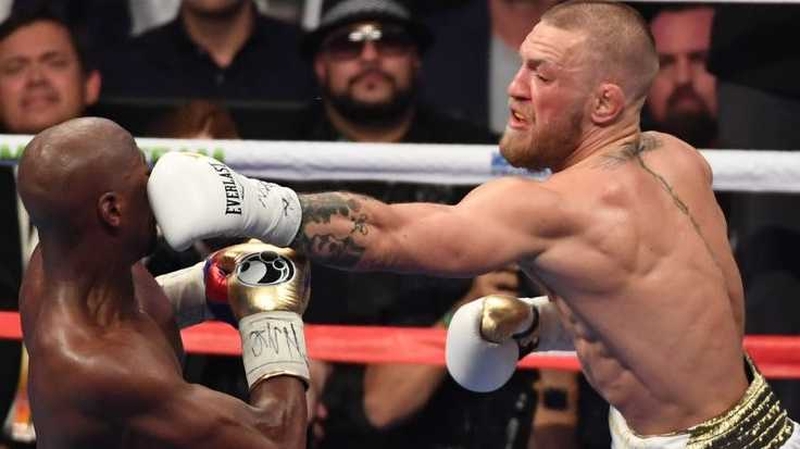 Conor McGregor lands a blow on Floyd Mayweather