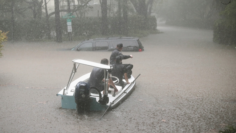 Volunteers and officers help rescue residents in the upscale River Oaks neighbourhood