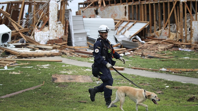 Robert Grant and Rocky from the Texas Task Force 2 search and rescue team at a destroyed apartment complex in Rockport, Texas