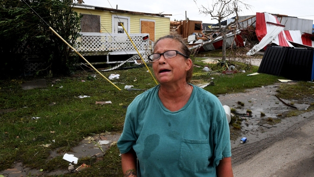 Local resident Kathy Neihaet walks through her damaged neighbourhood after Hurricane Harvey hit Port Aransas, Texas