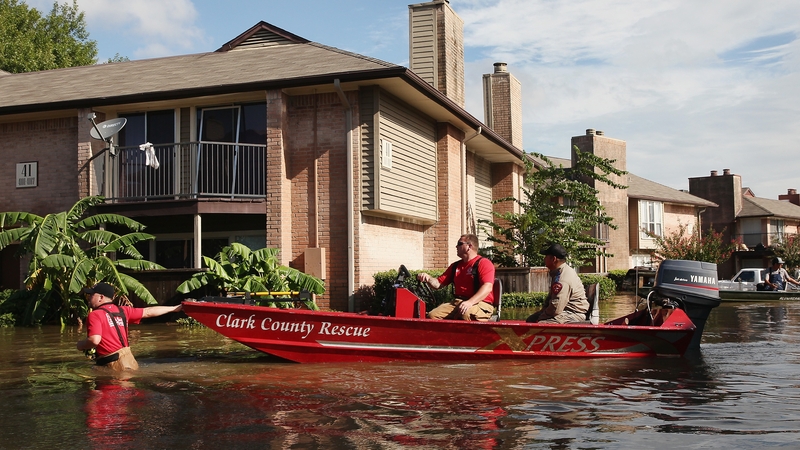 A Clark County Rescue boat helps people from their home