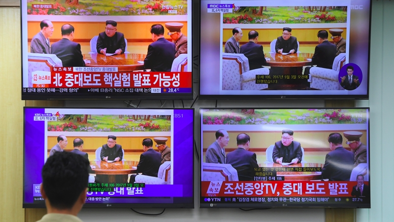 An Official in Seoul watches TV coverage of the test