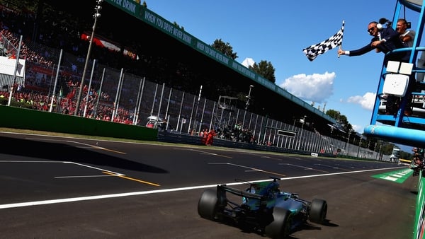 Lewis Hamilton crosses the to take the 2017 Italian GP