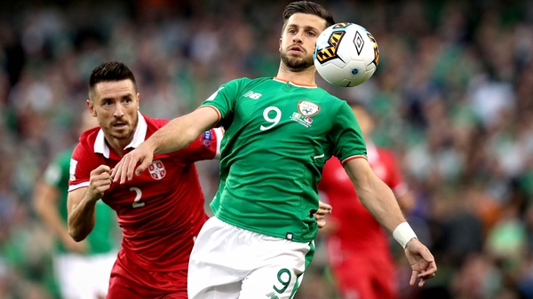 Shane Long battles with Antonio Rukavina of Serbia