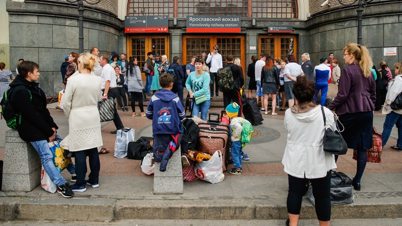 Passengers wait in front of the closed doors of Moscow's Yaroslavsky railway terminal in Moscow