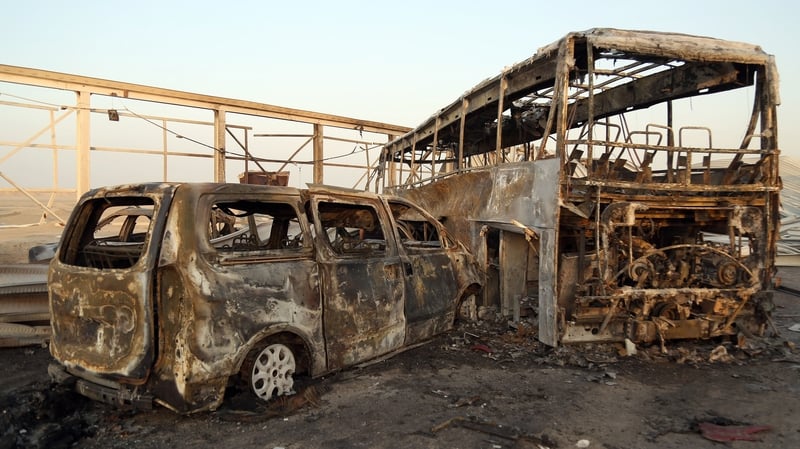 Burnt out vehicles after gunmen and suicide car bombers killed more than 70 people in two assaults