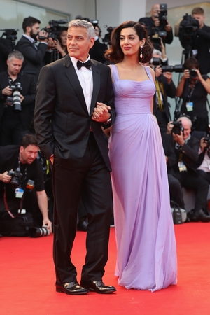George Clooney and Amal Clooney walk the red carpet ahead of the 'Suburbicon' screening. Amal stunned in this lilac Atelier Versace gown