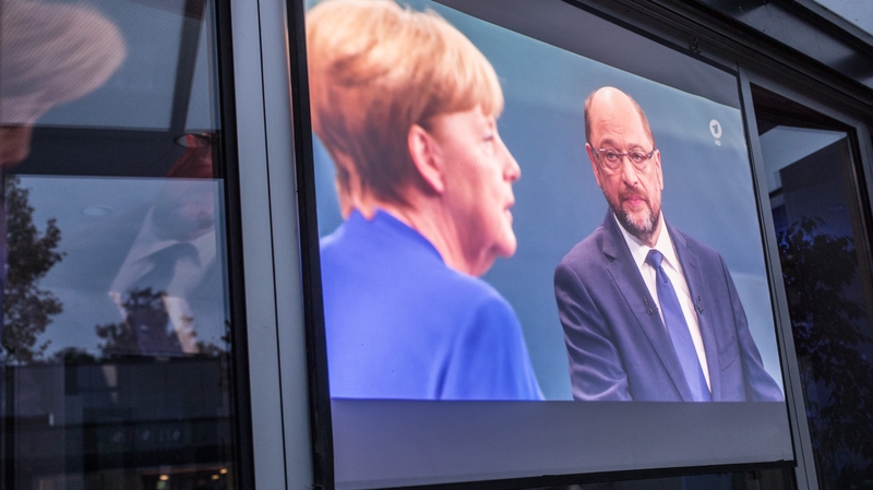 Chancellor Angela Merkel (L) and her main election rival Martin Schultz in tv debate from earlier in the campaign