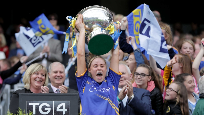 Samantha Lambert lifts the intermediate trophy