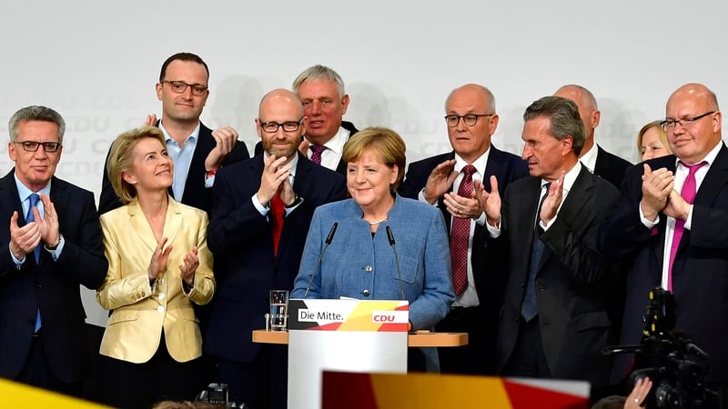 Angela Merkel (centre) and her CDU party members react to the exit polls this evening