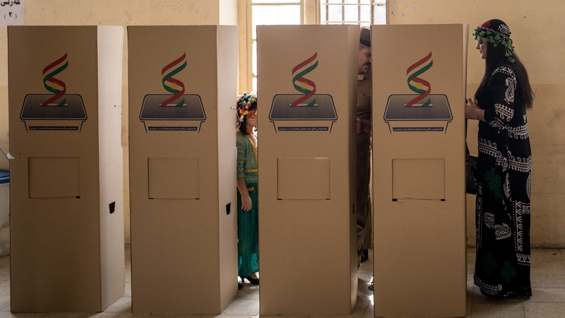 A woman waits to cast her referendum vote at a voting station in Kirkuk