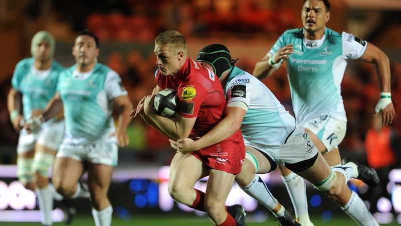 Johnny McNicholl of the Scarlets scores a try despite the attentions of Eoin McKeon