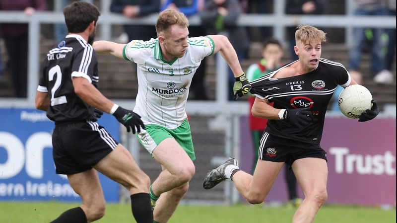 Burren's Geard McGovern with Jerome Johnston of Kilcoo