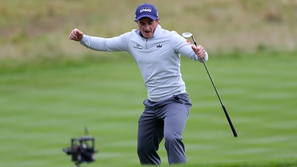 Paul Dunne celebrates chipping in at the 18th