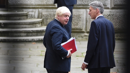 Philip Hammond (r) said Theresa May deserves backing from her ministers