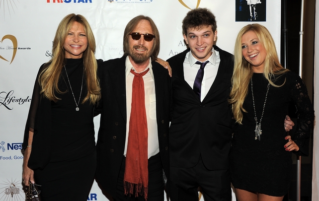 Tom's got the rock star accessories down as he poses with his wife Dana, step-son Dylan and a guest at the 11th Annual Golden Heart Awards in 2011