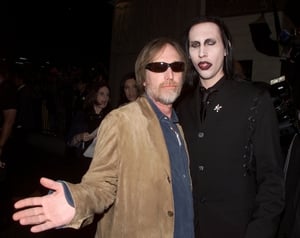 Tom Petty wears his statement sunglasses as he poses with Marilyn Manson at the premiere of 'Blow' in 2001