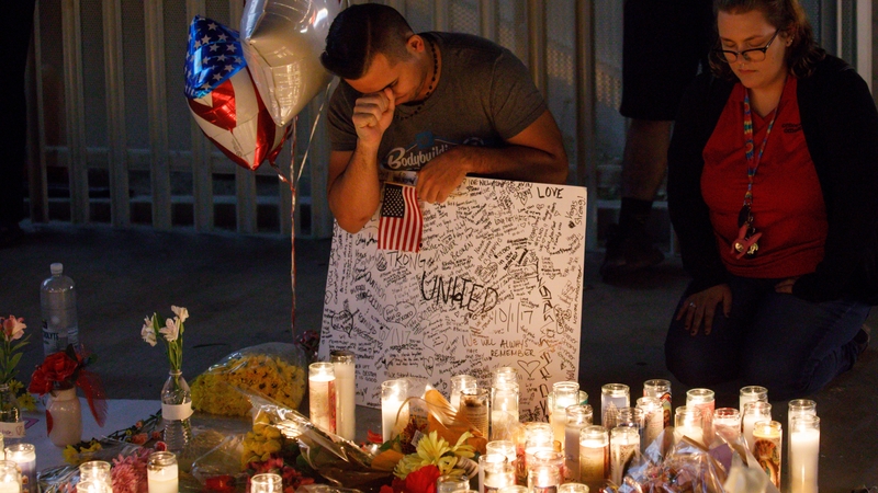 People gather at a memorial for the victims of the shooting in Las Vegas