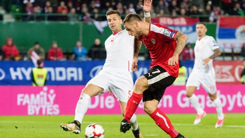 Austria's Marko Arnautovic (R) kicks the ball in front of Serbia's Matija Nastasic