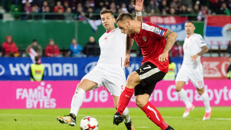 Austria's Marko Arnautovic (R) kicks the ball in front of Serbia's Matija Nastasic