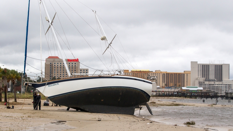 A large sailboat is washed ashore on a beach in Biloxi, Mississippi, by the storm