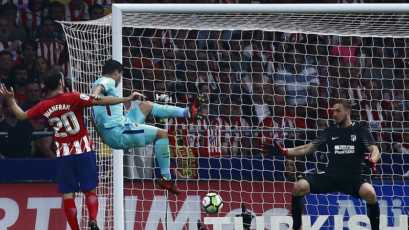 Luis Suarez scoring the equaliser that denies Atletico Madrid a victory.