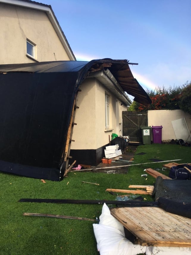 Debris scattered around a garden in Ballinteer, Dublin after a roof is ripped off a house