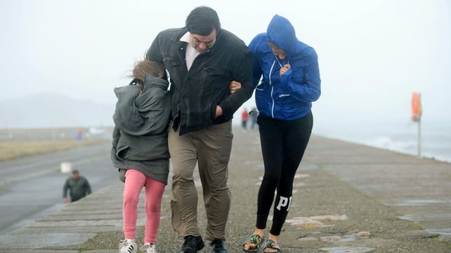 A family takes a walk on the East Pier in Howth, Dublin
