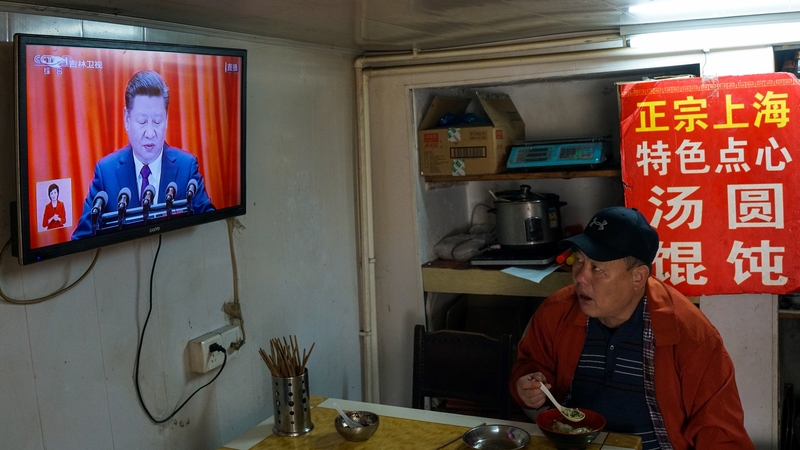 A man watches the opening of the 19th Communist Party Congress on a television in Shanghai