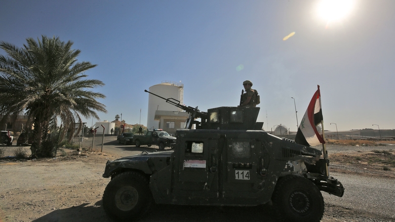 Iraqi forces guard an oil field west of Kirkuk