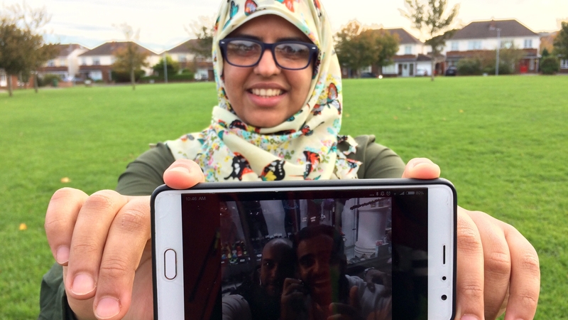 Fatima Halawa holding a picture of her brother