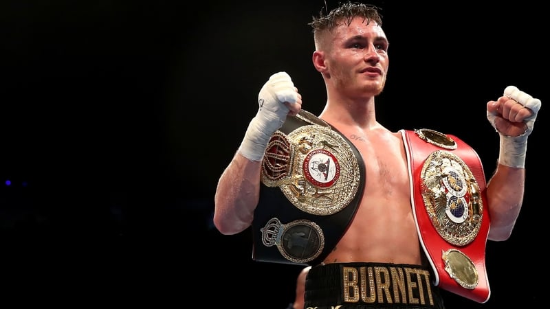 Ryan Burnett celebrates with his IBF and WBA belts