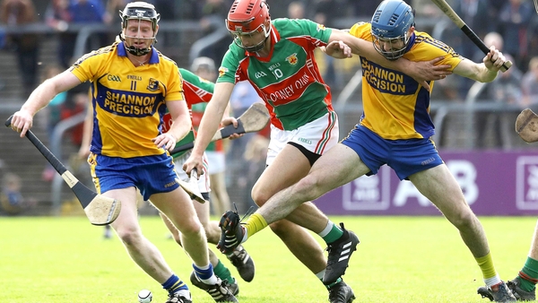 Clooney-Quin's Peter Duggan is tackled by Jamie Shanahan and Alex Morey of Sixmilebridge