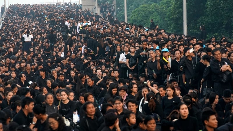 Thousands of people queue on a bridge to attend the funeral of the late Thai King Bhumibol Adulyadej