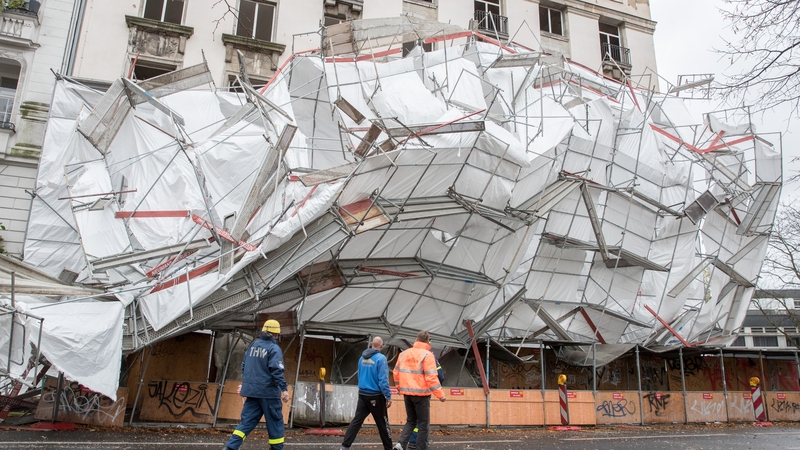 Emergency workers stand in front of scaffolding collapsed due to heavy winds in Berlin