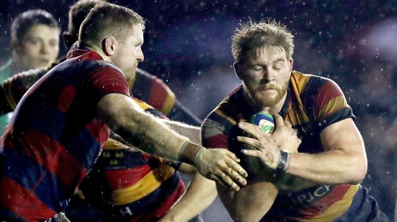 Clontarf's Royce Burke-Flynn (L) tries to halt Willie Earle of Lansdowne