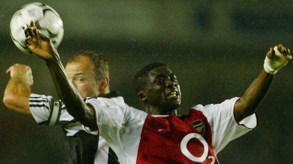 Alan Shearer (L) rises to head the ball against Arsenal's Kolo Toure in 2003