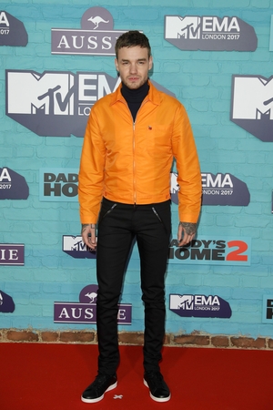 Liam Payne kept it casual before his EMA performance in black jeans and an orange jacket.