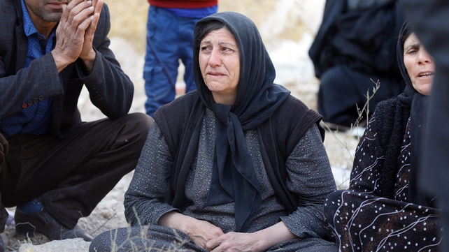 Victims of the earthquake gather around the wreckage of their home in the city of Pole-Zahab in Kermanshah