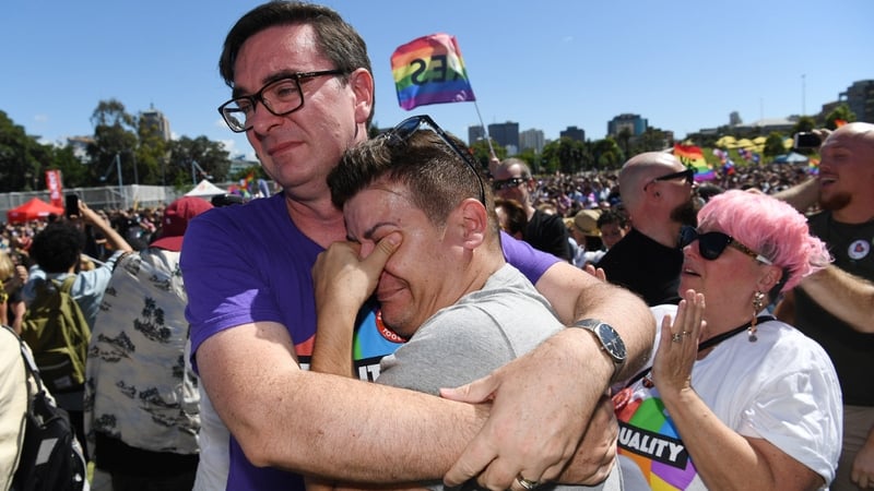 People celebrate after watching the same sex marriage vote result announcement during a picnic held by the Equality Campaign at Prince Regent Park in Sydney