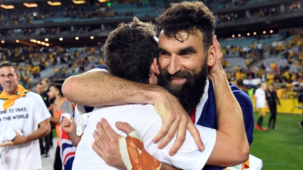 Australia's Robbie Kruse and Mile Jedinak (R) embrace