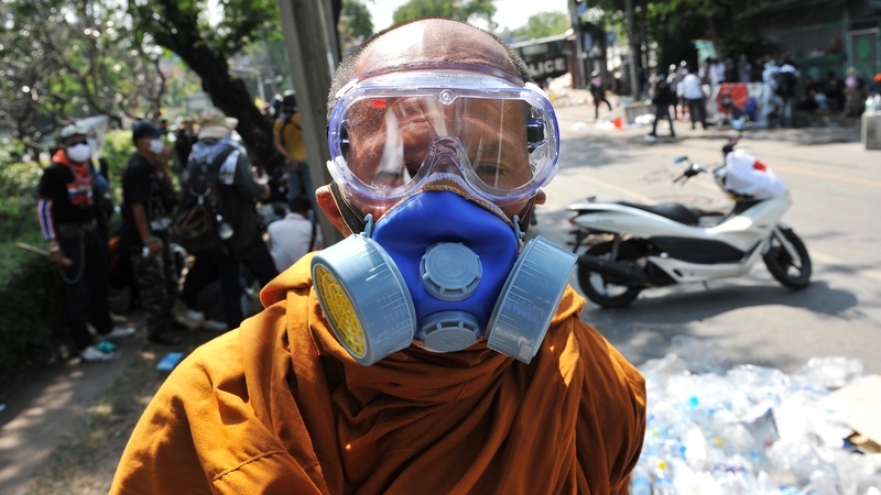 A Buddhist monk wearing a gas mask during protests in Bangkok in December 2013. Photo: Rufus Cox/Getty Images