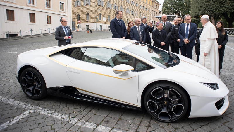 The car features gold stripes and gold-rimmed wing mirrors